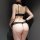 Woman wearing black transparent lace bodysuit with open-crotch design, showcasing seductive sleepwear for date night.