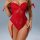 Woman wearing red transparent lace lingerie set with sheer push-up bralette and matching garter belt.