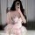 A woman poses with a leopard phone case, wearing a shimmering pink corset dress paired with a voluminous tutu skirt. the outf...