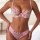 Woman wearing a transparent mesh lace bra set with embroidered floral details and sheer cups, paired with matching panties.