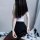A woman models a transparent bodysuit paired with a black pencil skirt and matching thong, creating an elegant and seductive ...