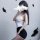 A woman poses with a smartphone, partially obscuring her face with smoke. she wears a white open-crotch bodysuit paired with ...
