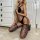 Blonde woman kneeling in black sheer open-crotch bodysuit with off-shoulder straps and lace thigh-high stockings.