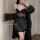 Woman wearing black transparent sexy lingerie set with sheer lace details and matching robe for couples play.