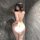 Woman wearing ultra-sexy spicy lace see-through lingerie set with seductive chains, posing provocatively against a marble wal...