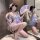 A woman poses elegantly in a sheer kimono robe adorned with butterfly prints, featuring lace-up details and flirty design ele...