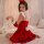 A woman poses in a festive red velvet christmas lingerie set, featuring a charming lolita design with white accents and fluff...