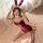 A woman poses playfully wearing a velvet red new year-themed lingerie set, featuring bunny ears and fur accents, perfect for ...
