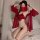 Woman in red sheer mask and heart-shaped tassel lingerie set, posing on bed with vintage chinese costume role play outfit.