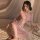 Woman wearing a vintage chinese-inspired lace cheongsam lingerie set with sheer mesh and floral details, styled in a retro ha...