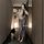 Woman modeling vintage chinese-inspired lace see-through cheongsam lingerie set, holding a fan in a modern hallway.