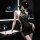 Woman wearing black vintage lace side-tie cheongsam lingerie set in a modern bathroom setting.