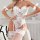 Woman modeling white lace shapewear bodysuit with bow silk ties, paired with matching stockings and garters.