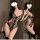 Woman in mirror wearing wild leopard print bodysuit, sexy strapless thong set with backless design and lace trim.
