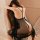 Woman wearing wild rose sheer lace sleep dress & matching thong set, seated on ornate chair, back view showing delicate strap...