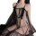 Woman wearing wild rose sheer lace sleep dress with matching thong, featuring transparent fabric and bow details.