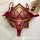 Wine red plus size lingerie set with sheer mesh bra and panty, featuring lace cutouts, displayed on a wooden tray with a cand...