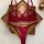 Wine red plus size lingerie set featuring a sheer mesh bra and panty with lace cutouts, displayed on a wooden tray.
