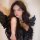 Woman in black lace sleep set with angel wings, romantic lingerie for couples.