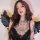 Woman wearing black lace lingerie set with intricate tattoos and angel wings, showcasing elegant and romantic sleepwear desig...
