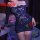 Woman wearing a navy blue lace bodycon skirt set with one-shoulder design, holding a red rose in a romantic bedroom setting.