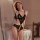 Woman wearing black lace bodysuit with open crotch, posing seductively on bed — romantic, tight-fit design for small bust.