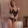 Woman wearing black lace bodysuit with open crotch, sheer panels, and delicate straps; romantic, form-fitting lingerie for sm...