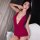 Woman wearing a deep red halter chemise with sheer mesh details, styled as seductive sleepwear.