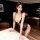 Woman modeling black lace sheer bodysuit, a seductive no-remove lingerie dress for pure and tempting sleepwear.