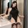 Woman in black ice silk bodysuit with open crotch, fishnet cami design, tight fit, sheer fabric, thigh-high stockings, bathro...