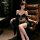 Woman wearing black fringe lingerie set with matching robe, seated in leather chair. elegant and alluring design for mature w...