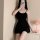 A woman poses with a black bodycon dress featuring a sexy backless design, high elasticity, and adjustable straps, creating a...