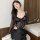 Woman wearing a black lace bodysuit with sheer sleeves and intricate floral patterns, styled for a sexy yet elegant look.