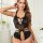 Woman modeling black lace bodysuit with open crotch and backless design, featuring floral patterns and decorative chains.