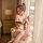 A woman sits elegantly by a window wearing a floral kimono-inspired bodysuit set, featuring sheer lace details and an open de...