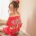 A woman elegantly poses wearing a vibrant red kimono-inspired bodysuit set, featuring floral patterns and delicate lace detai...