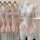 Womens floral lace corset top with push-up padded cups and ruffled skirt, displayed on mannequin and hangers.