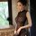 A woman elegantly poses in a sheer lace cheongsam dress, featuring vintage-inspired floral trim and a classic design, perfect...
