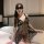 Woman wearing black lace transparent babydoll set with sheer fabric and bow details, styled as seductive sleepwear lingerie o...