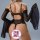 Woman wearing black sheer lace open-crotch sleepwear set with matching robe, back view showing seductive design for date nigh...