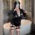 Woman wearing black police officer costume with cap, badge, and fishnet stockings in bathroom mirror selfie.