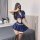 Woman in navy blue police-themed lingerie set with short skirt and crop top, posing in bedroom. perfect for parties or date n...