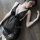 Woman lying on wooden floor in sheer black lace lingerie set, romantic and elegant sleepwear for couples.