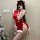 A woman poses in a festive red cheongsam outfit, featuring sheer bust design and fluffy white trimmings, perfect for holiday ...