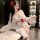 A woman poses elegantly wearing a sheer kimono-inspired uniform from xianyi, featuring floral prints and lace details, perfec...