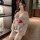 A woman models a sheer kimono-inspired uniform with floral patterns, featuring lace details and a red sash, perfect for intim...