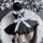 A person wearing a black maid costume with white apron and bow tie, sitting on a fluffy rug surrounded by balls. perfect for ...