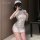 Woman wearing white xianyi nurse costume with open-crotch design, posing seductively for cosplay role play lingerie look.