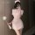 Woman in pink xianyi nurse costume with open-crotch design, holding a fluffy wand, posing for a mirror selfie.
