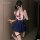 Woman in xianyi womens high-end restrained-luxe lingerie set, featuring a navy skirt and white top with red tie, posing indoo...